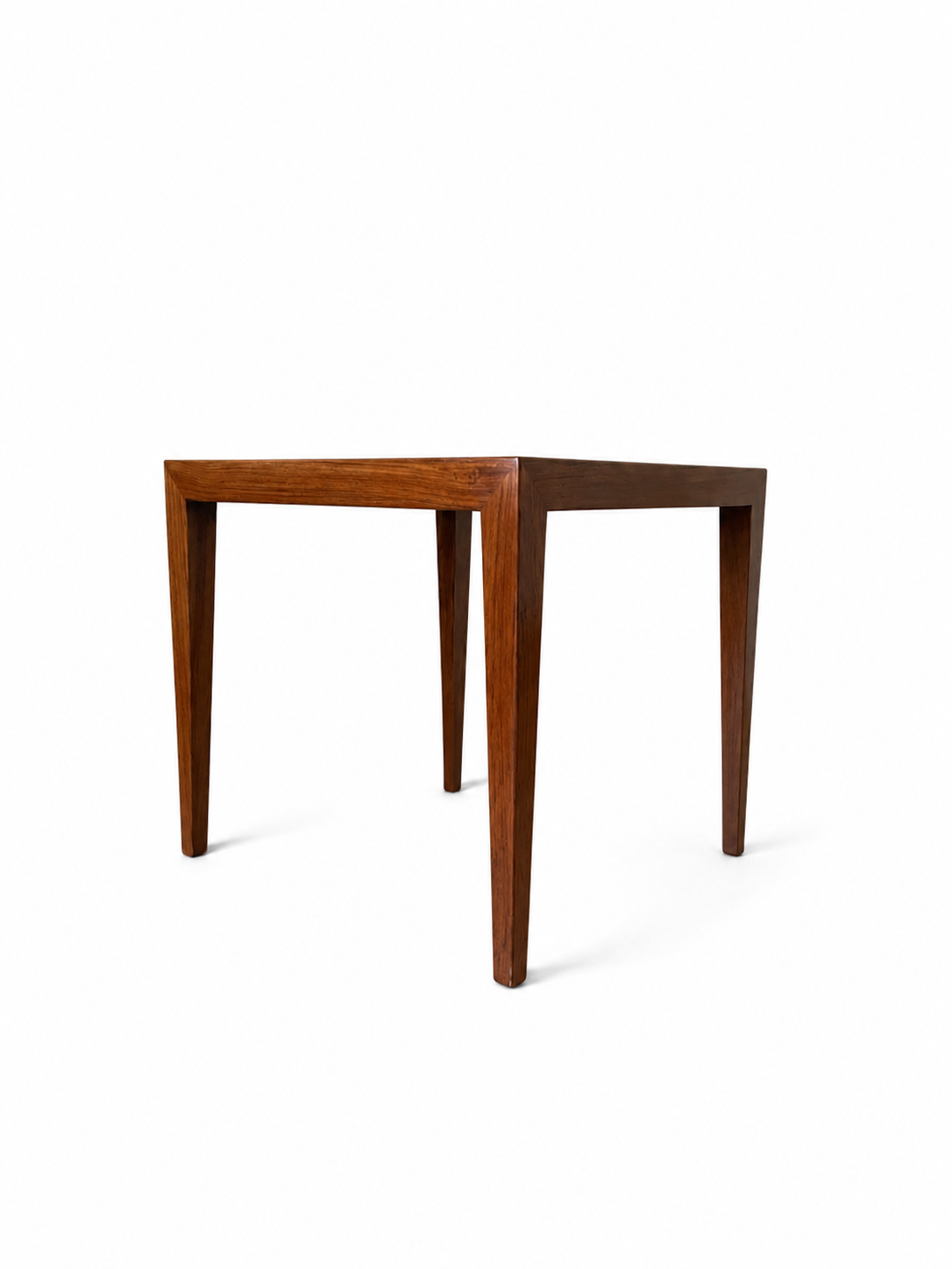 A square wooden table with tapered legs and a medium brown finish, shown from a three-quarters angle on a white background.