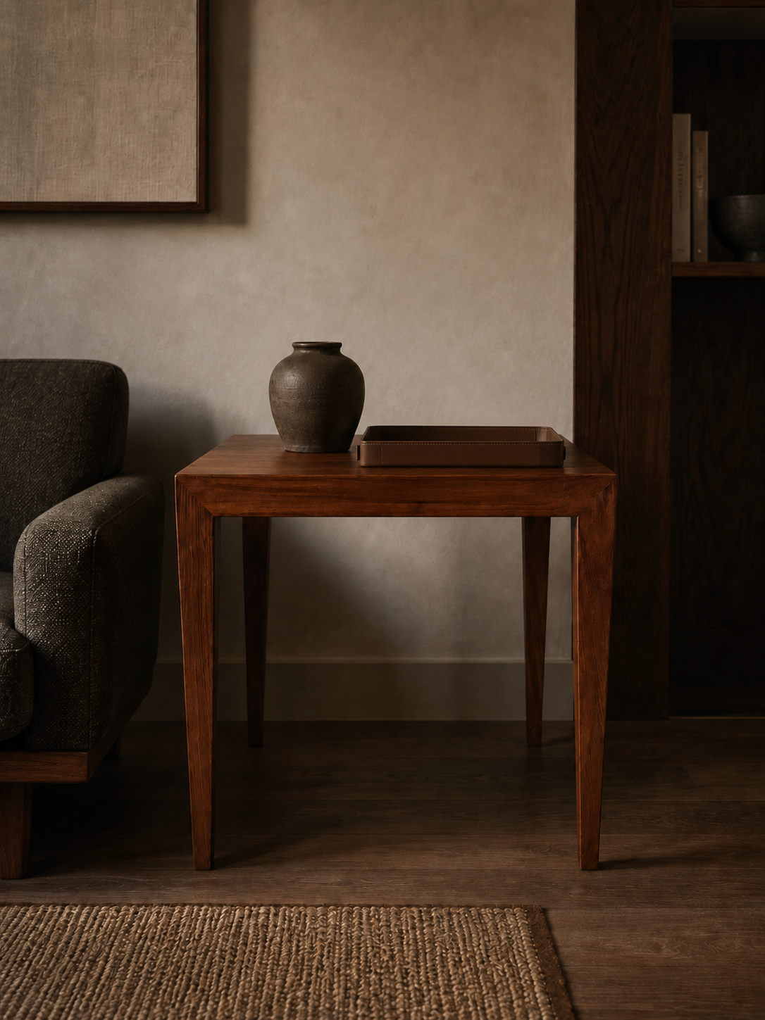Wooden side table with a vase in a dimly lit room
